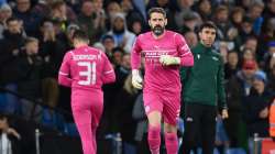 Scott Carson of Manchester City makes his way onto the pitch to replace teammate Ederson during the 