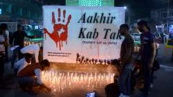 Kashmiri Pandits take part in a candle light protest against the killing of 3 persons including pharmacist ML Bindroo by militants, at Ghanta Ghar in Srinagar, Wednesday evening, Oct. 6, 2021.