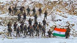 Indian Army soldiers pose for a photograph with the national flag on the occasion of New Year 2022, at the Galwan Valley in Ladakh, Tuesday, Jan. 4, 2022.?