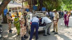 Delhi Police personnel check a vehicle at the Rohini Court in New Delhi, Saturday, Sept 25, 2021.