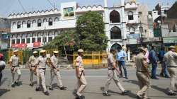 Security personnel stand guard, after clashes broke out between two communities during a Hanuman Jayanti procession on Saturday, at Jahangirpuri in New Delhi, Monday, April 18, 2022.