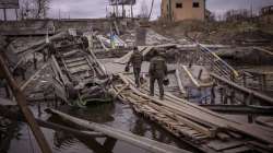 Ukrainian soldiers walk on a destroyed bridge in Irpin, on the outskirts of Kyiv, on Wednesday, April 20, 2022.