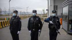 Police officers stand at the outer entrance of the Urumqi No. 3 Detention Center in Dabancheng in western China's Xinjiang Uyghur Autonomous Region