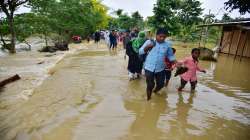 Hojai: Villagers wade through a flood affected area following heavy rains in Hojai district of Assam, Monday, May 16, 2022.