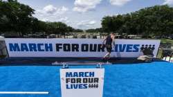 Workers set up for the March for Our Lives rally on the National Mall near the White House in Washington. 