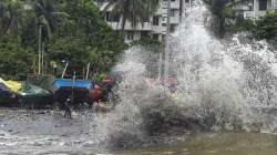 Mumbai: Sea waves lash the slums and boats at the shore during high tide