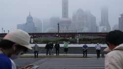 Residents cross the road near the bund as day breaks, Wednesday, June 1, 2022, in Shanghai. Shanghai authorities say they will take major steps Wednesday toward reopening China's largest city after a two-month COVID-19 lockdown that has set back the national economy and largely confined millions of people to their homes.?