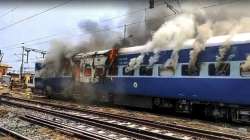 Smoke billows out after youngsters set a train on fire in protest against the Agnipath scheme at Chapra railway station in Saran district on Thursday, June 16