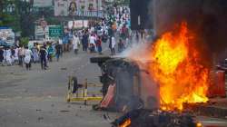 Flames and smoke rise from a vehicle on fire, that was allegedly set ablaze by miscreants during a protest in Howrah over controversial remarks made by two now-suspended BJP leaders about Prophet Mohammad.