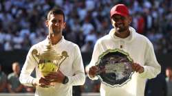 Novak Djokovic and Nick Kyrgios pose with their trophies 