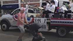 A Fourth of July parade-goer runs for cover after gunfire was heard at the parade Monday morning, July 4, 2022, in a suburb of Chicago.