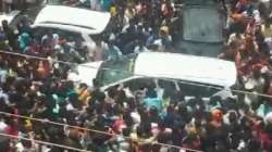 Party worker surround a BJP MPs car in protest against the murder.  