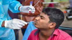 A medic collects swab sample of a commuter for Covid-19 test.