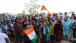 Kashmiri Pandits block the Jammu-Akhnoor National Highway during a protest over the killing of Rahul Bhat, in Jammu, Saturday, May 21, 2022.