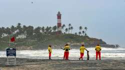 Lifeguards stand near the shore at a beach in Kovalam, in Thiruvananthapuram. 
