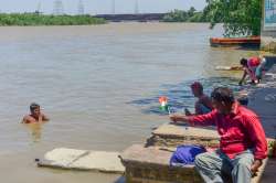 A man swims in the swollen Yamuna river, following monsoon rains in upper catchment areas in New Delhi.