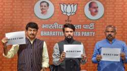 Union Minister Anurag Thakur flanked by Delhi BJP President Adesh Gupta and BJP MP Manoj Tiwari addresses a press conference at BJP headquarters in New Delhi. 