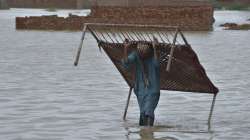 A man carries cot after he salvaged it from his flood-hit home in Jaffarabad, a district of Pakistan's southwestern Baluchistan province. 