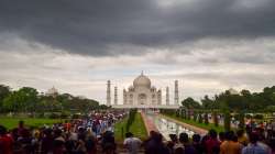 Tourists in large numbers, owing to the national holiday on Independence Day, visit the Taj Mahal as dark monsoon clouds fill the sky, in Agra, Monday, Aug. 15, 2022.