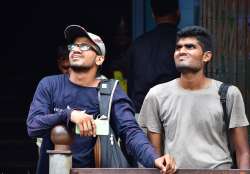 People at Mumbai's Dalal Street witness stock market closing.   