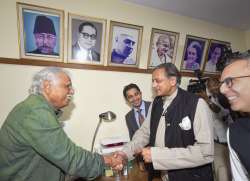 Senior Congress leader and MP Shashi Tharoor interacts with Congress Central Election Authority Chairman Madhusudan Mistry 