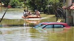 Fire fighters while evacuating residents from flooded Rainbow Drive Layout locality after heavy monsoon rains at Sarjapur, in Bengaluru, Monday.