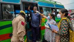 Jammu: A healthcare worker takes a swab sample from a man for Covid-19 testing