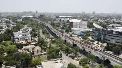 An aerial view of a train running on its tracks after Delhi Metro services resumed, in Gurugram.