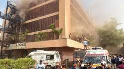 Lucknow:Fire Brigade personnel try to evacuate people after a fire broke out in a hotel in Hazratganj area of Lucknow, Monday morning. Sept. 5, 2022. 