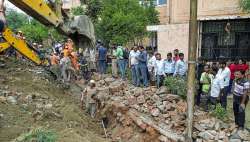 Noida: Rescue operation underway after a portion of a boundary wall of a housing society collapsed, at Jal Vayu Vihar in Noida, Tuesday, Sept. 20, 2022.