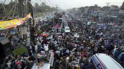 Supporters of Pakistan's main opposition 'Tehreek-e-Insaf party' listen the speech of their leader Imran Khan at a rally in Lahore, Pakistan.