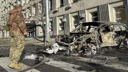 Rescue workers survey the scene of a Russian attack on Kyiv, Ukraine