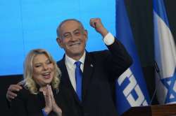 Former Israeli Prime Minister and the head of Likud party, Benjamin Netanyahu and his wife Sara gesture after first exit poll results for the Israeli Parliamentary election at his party's headquarters in Jerusalem