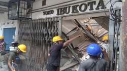 Workers inspect a store damaged during an earthquake in Cianjur, West Java, Indonesia, Monday, Nov. 21, 2022.