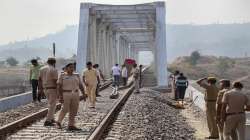 Police personnel investigate after an explosion on Udaipur-Ahmedabad railway track in Udaipur.