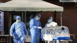 Medical workers in protective gear prepare equipment outside a fever clinic at a hospital in Beijing, Friday, Dec. 9, 2022. 