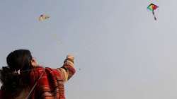 A woman participates in the kite flying festival on the occasion of Makar Sankranti. 