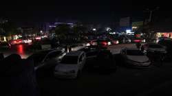 A car drive in a market, where some shopkeeper are using generators for electricity during a national-wide power breakdown, in Islamabad, Pakistan.