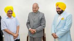 AAP leader Bhagwant Mann with Delhi Chief Minister and AAP Convener Arvind Kejriwal and Punjab Governor Banwarilal Purohit.