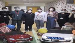 Children drive to their treatment rooms on electric toy cars.