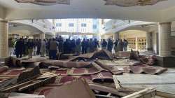 Security officials and rescue workers gather at the site of suicide bombing inside a mosque, in Peshawar, Pakistan