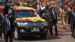 Prime Minister Narendra Modi waves at supporters during a roadshow, in Belagavi, Karnataka