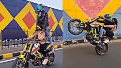 Couple performs dangerous bike stunts