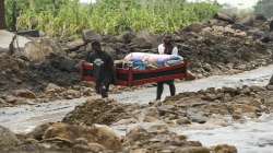 Men transport their salvaged belongings in Chiradzulu, southern Malawi. 