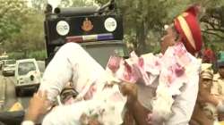 During Congress' protest over Adani row, one of the protesters, dressed like a groom tries to cross the barricade.