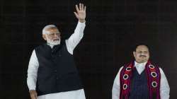 Prime Minister Narendra Modi waves at BJP workers as party President JP Nadda looks on during celebrations after the party's performance in Nagaland, Tripura and Meghalaya Assembly polls, at the BJP HQ in New Delhi.