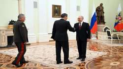 Russian President Vladimir Putin and Chinese Defense Minister Gen Li Shangfu shake hands during their meeting at the Kremlin in Moscow.
