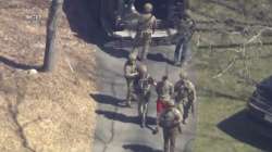  Jack Teixeira, in T-shirt and shorts, being taken into custody by armed tactical agents on Thursday