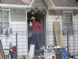 San Jacinto County Sheriff Greg Capers talks to investigators at the scene where five people were shot and killed the night before, Saturday.