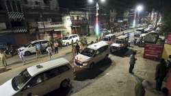 Police personnel at the crime scene where mafia-turned-politician Atiq Ahmed and his brother Khalid Azim aka Ashraf were shot dead while being taken for medical checkup to a hospital, in Prayagraj.